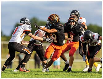 A group of football players on a field. Description generated by AI