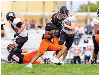 A group of football players on a field. Description generated by AI