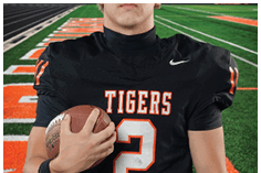 A young man wearing a white jersey with the number 10 on it. Description generated by AI