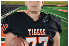 A young man wearing a white jersey with the number 10 on it. Description generated by AI