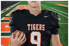A young man wearing a white jersey with the number 10 on it. Description generated by AI