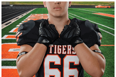 A young man wearing a white jersey with the number 10 on it. Description generated by AI