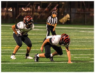 A group of football players on a field. Description generated by AI