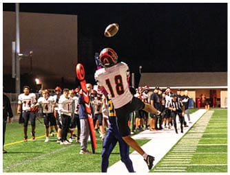 A group of football players on a field. Description generated by AI