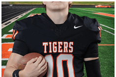 A young man wearing a white jersey with the number 10 on it. Description generated by AI