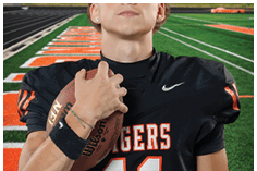 A young man wearing a white jersey with the number 10 on it. Description generated by AI