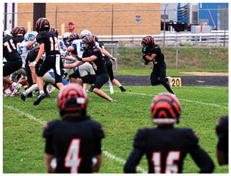 A group of football players on a field. Description generated by AI