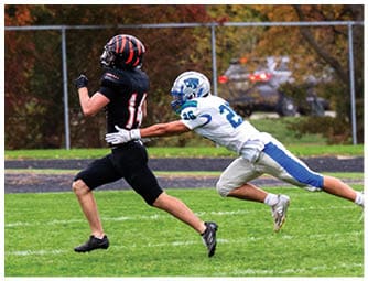 A group of football players on a field. Description generated by AI
