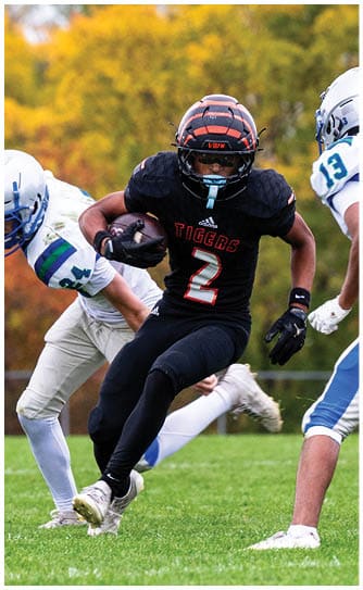 A football player catching a ball. Description generated by AI
