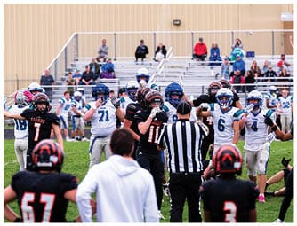 A group of football players on a field. Description generated by AI