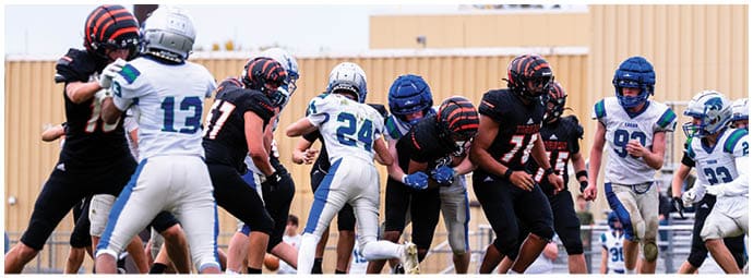 A football player wearing a blue and white uniform. Description generated by AI
