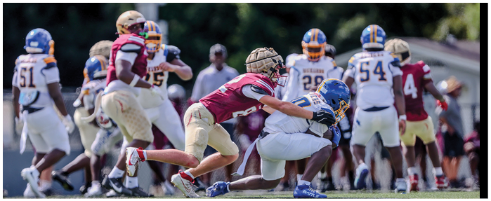 A football game is taking place with players on the field. Description generated by AI