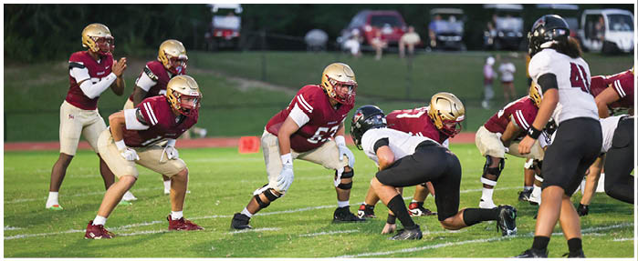 A football game is taking place with players on the field. Description generated by AI