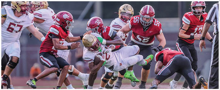A football game is taking place with players on the field. Description generated by AI