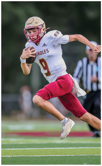 A football player catching a ball. Description generated by AI