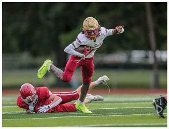 A group of football players on a field. Description generated by AI