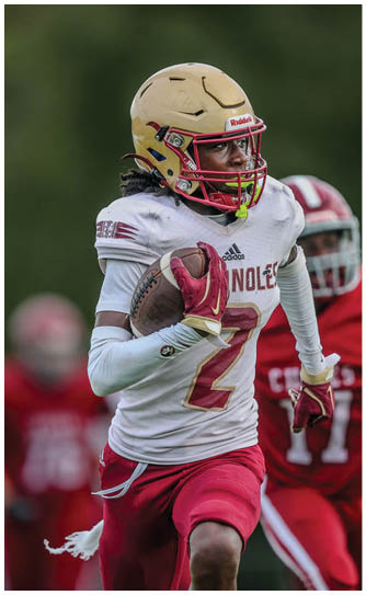 A football player catching a ball. Description generated by AI