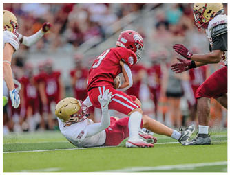 A group of football players on a field. Description generated by AI