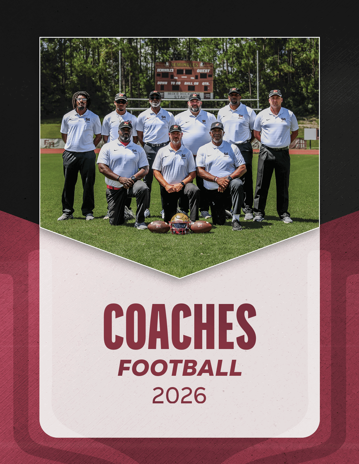 A group of eight adults wearing white polo shirts and dark pants pose on a football field with helmets and footballs in front of them under a scoreboard, with the text “Coaches Football 2026" below. Description generated by AI