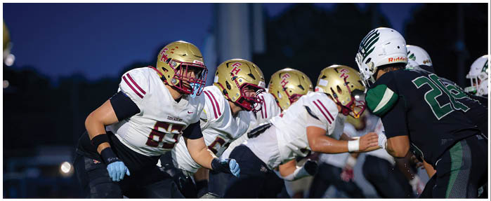 A football game is taking place with players on the field. Description generated by AI