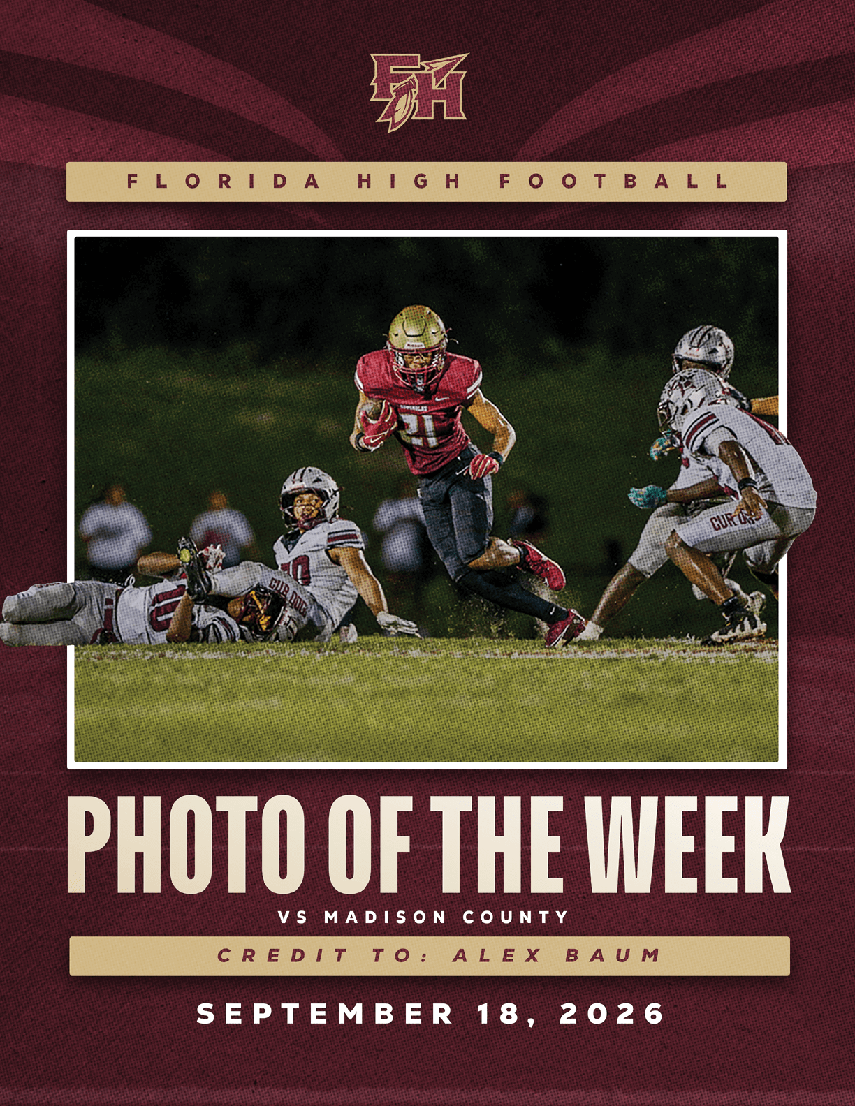 Three football players in action on a field with two players in white uniforms tackling a player in a red uniform during a game. Description generated by AI