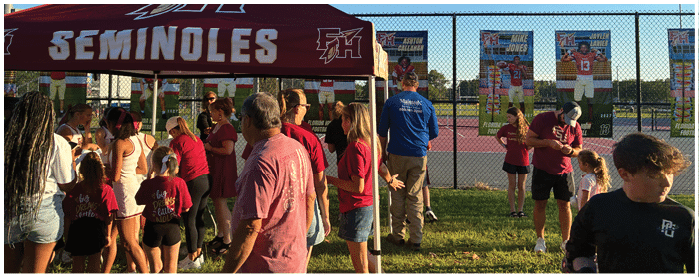 A football game is taking place with players on the field. Description generated by AI