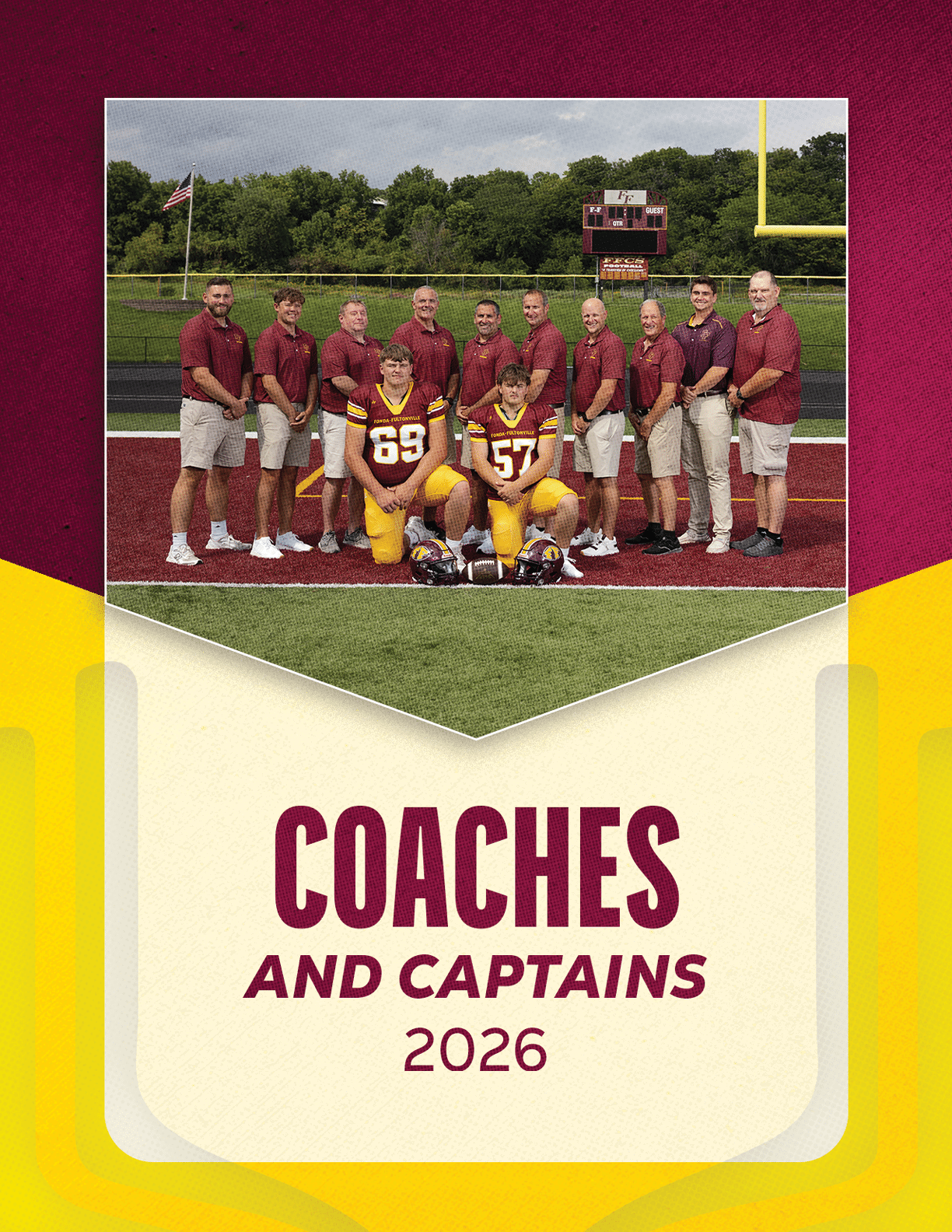 A group of adults wearing matching maroon shirts and khaki shorts stand behind two adults in football uniforms kneeling on a football field with a scoreboard and goalpost in the background, above text reading coaches and captains 2026. Description generated by AI