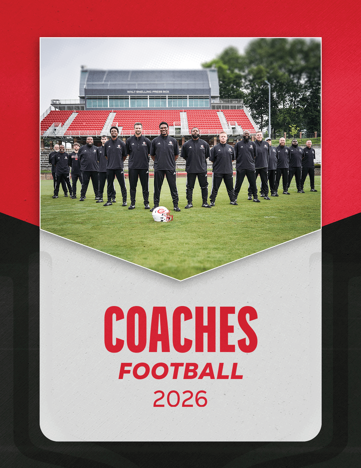 A group of people dressed in black sportswear stands on a soccer field in front of red and white stadium seats with a soccer ball placed on the grass in front of them and the text “COACHES FOOTBALL 2026" below. Description generated by AI