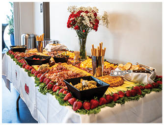 A television screen mounted on a wall displays a red graphic with the text “Night of Sponsors" above a bouquet of red and white flowers. Description generated by AI