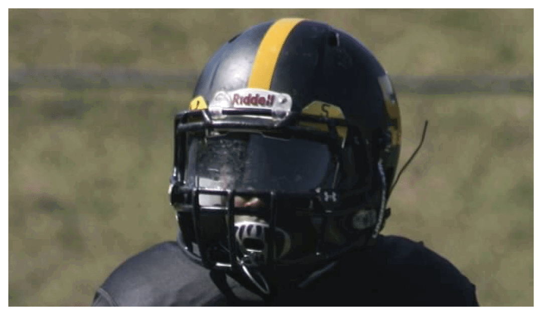 A football player wearing a blue and red jersey. Description generated by AI