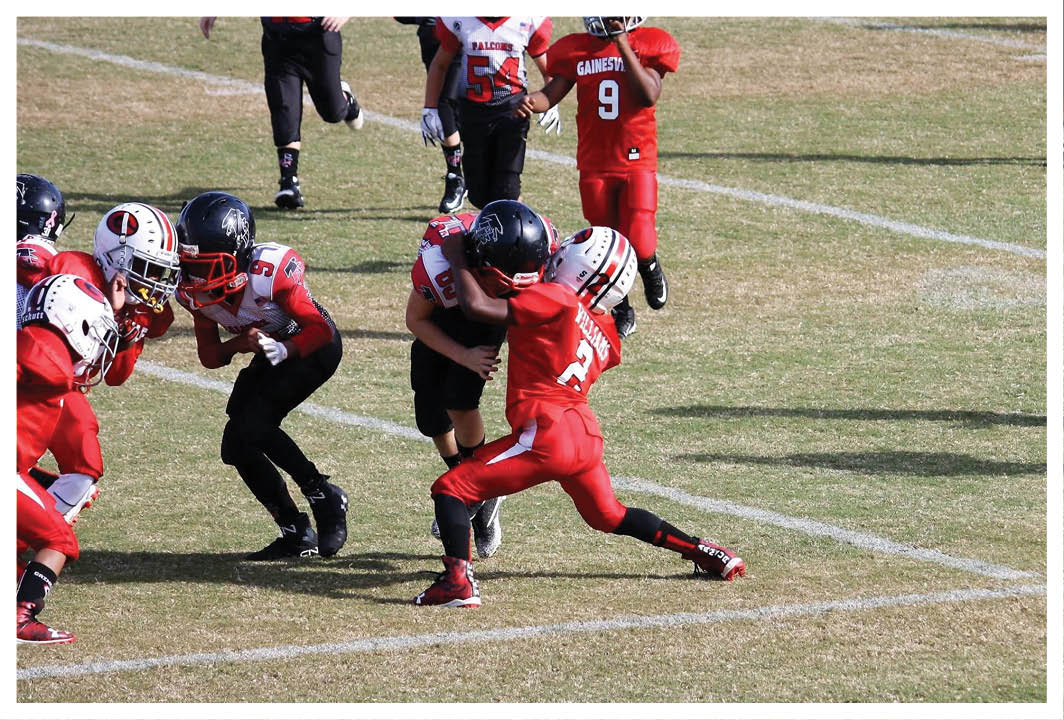 A football player wearing a blue and red jersey. Description generated by AI