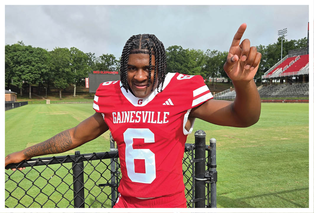 A football player wearing a blue and red jersey. Description generated by AI