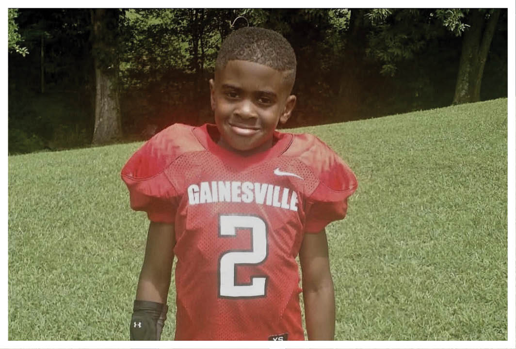 A football player wearing a blue and red jersey. Description generated by AI