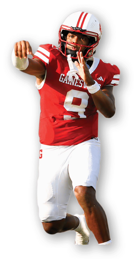 A person wearing a red and white football uniform with the number 9 is preparing to throw a football on a grassy field. Description generated by AI
