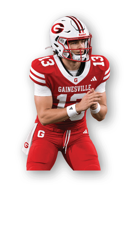 A person wearing a red and white Gainesville football uniform with the number 13 on the jersey and helmet is in a ready stance on a dark background. Description generated by AI