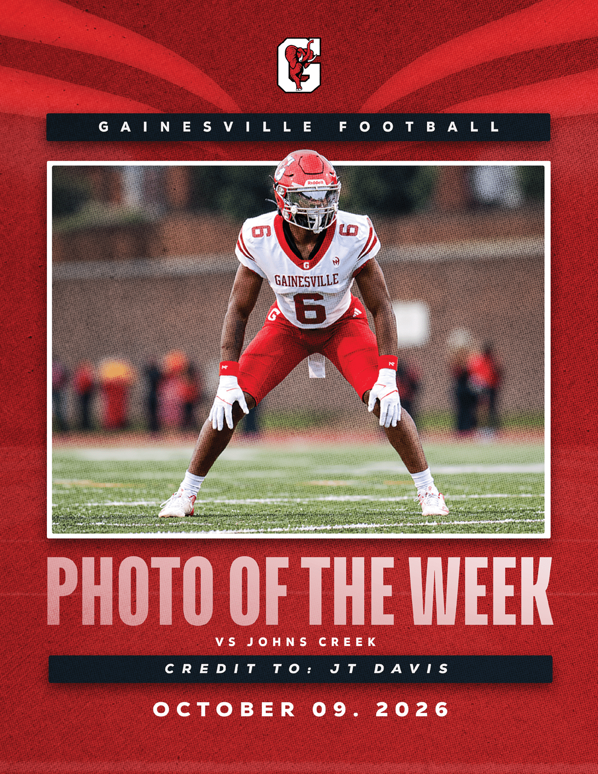 A person in a red and white football uniform with the number six is in a ready stance on a football field with a blurred background, featured as the photo of the week for Gainesville Football against Johns Creek. Description generated by AI