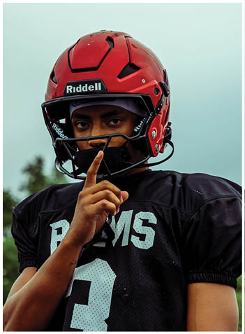 A football player wearing a blue jersey with the number 58 on it. Description generated by AI
