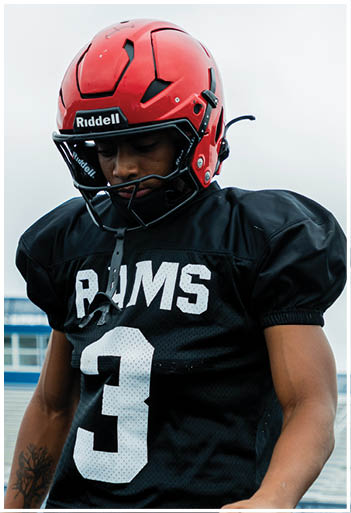 A football player running on the field. Description generated by AI