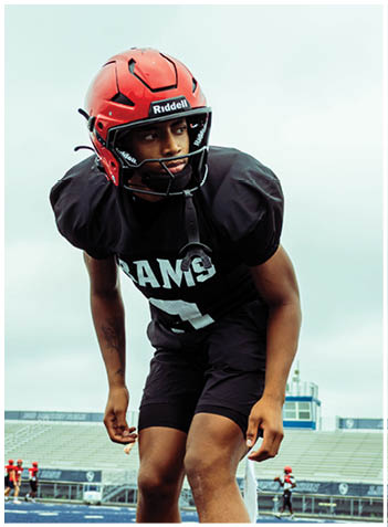 A football player wearing a blue jersey with the number 58 on it. Description generated by AI