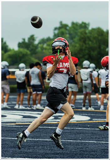 A football player running on the field. Description generated by AI