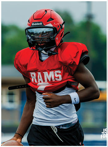 A football player wearing a blue jersey with the number 58 on it. Description generated by AI
