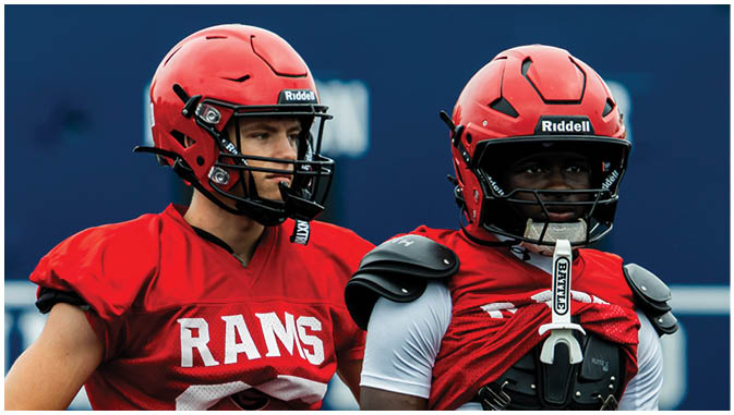 A group of football players on a field. Description generated by AI