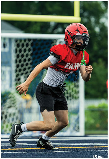 A football player running on the field. Description generated by AI
