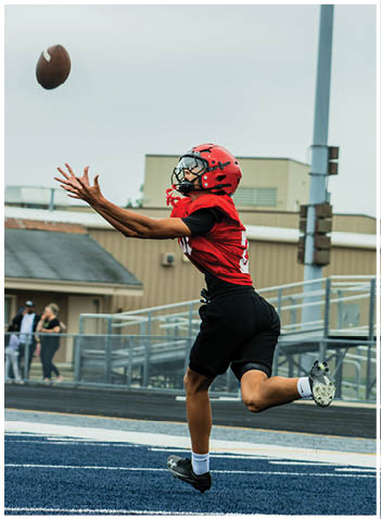 A football player wearing a blue jersey with the number 58 on it. Description generated by AI