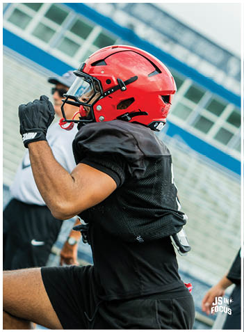 A football player wearing a blue jersey with the number 58 on it. Description generated by AI