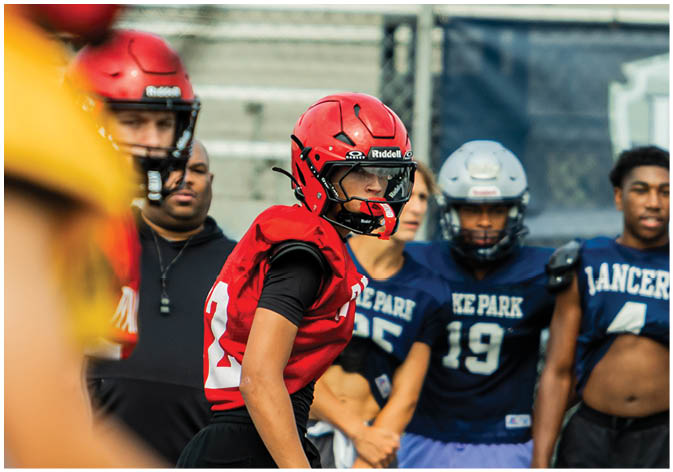 A group of football players wearing black and white uniforms. Description generated by AI