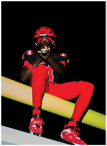 A football player wearing a blue jersey with the number 58 on it. Description generated by AI