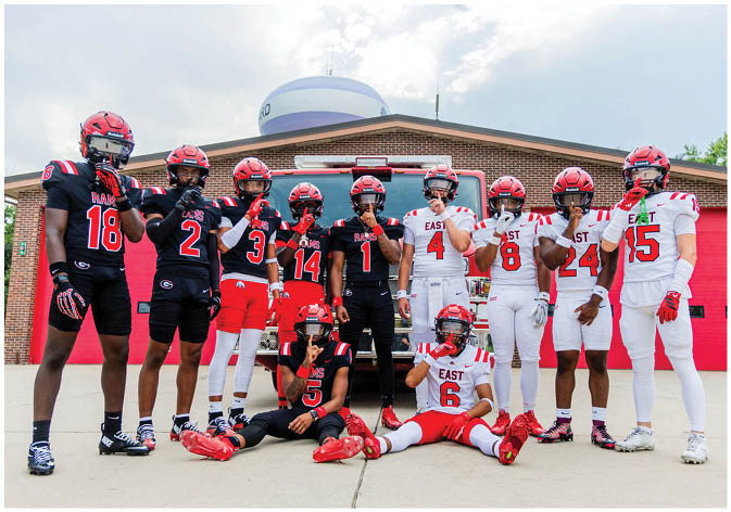 A group of football players wearing black and white uniforms. Description generated by AI