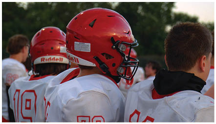 A group of football players on a field. Description generated by AI