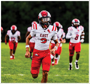 A group of football players celebrating a touchdown. Description generated by AI